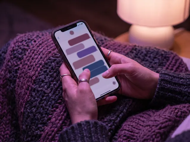 Illustrative image: hands holding a phone with a chat in the evening
