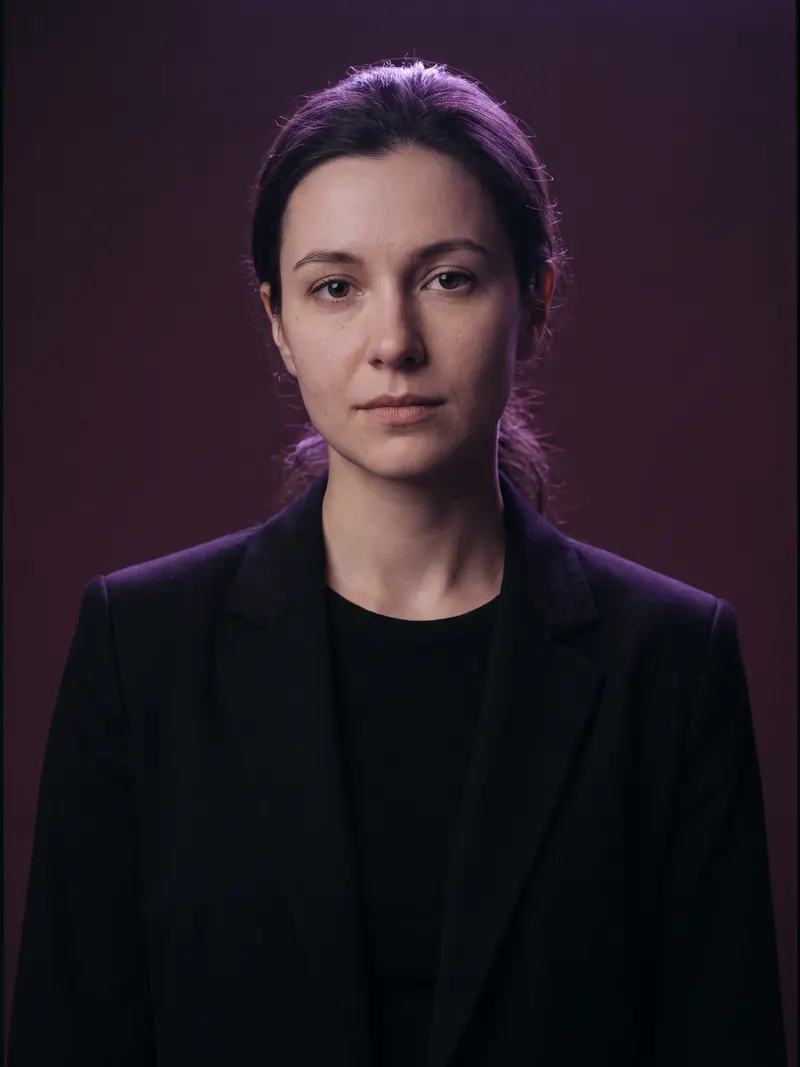 Illustrative image: studio portrait in a blazer under violet light
